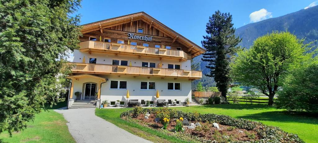 a large building with a balcony on the side of it at Apartments Rosenhof in Mayrhofen