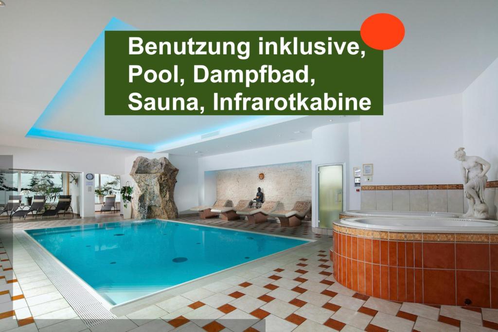 a swimming pool in a hotel with the words banking inclusive poolmanaged at Ferienwohnungen Weiherbach - Hallenbad in Berchtesgaden