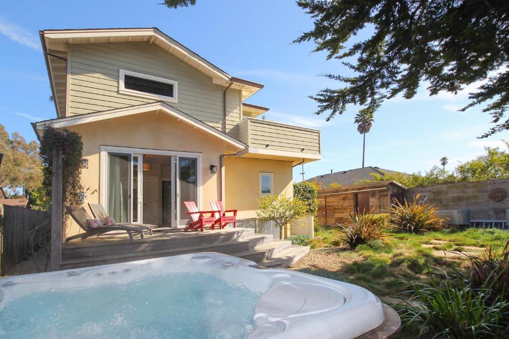 a house with a hot tub in front of it at Pleasure Point Retreat in Santa Cruz