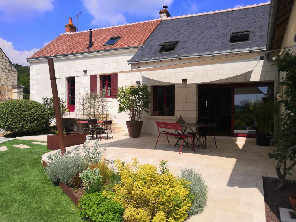 a house with a patio with tables and chairs at Cottage l'Orée du Cher in Chissay-en-Touraine