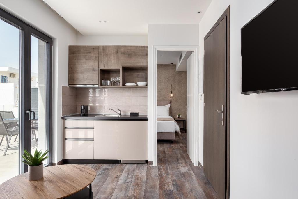 a kitchen with a sink and a bedroom with a bed at Athenian Spirit in Athens