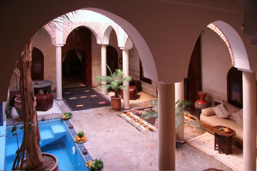 a large room with a swimming pool in a house at Riad Zen House in Marrakech