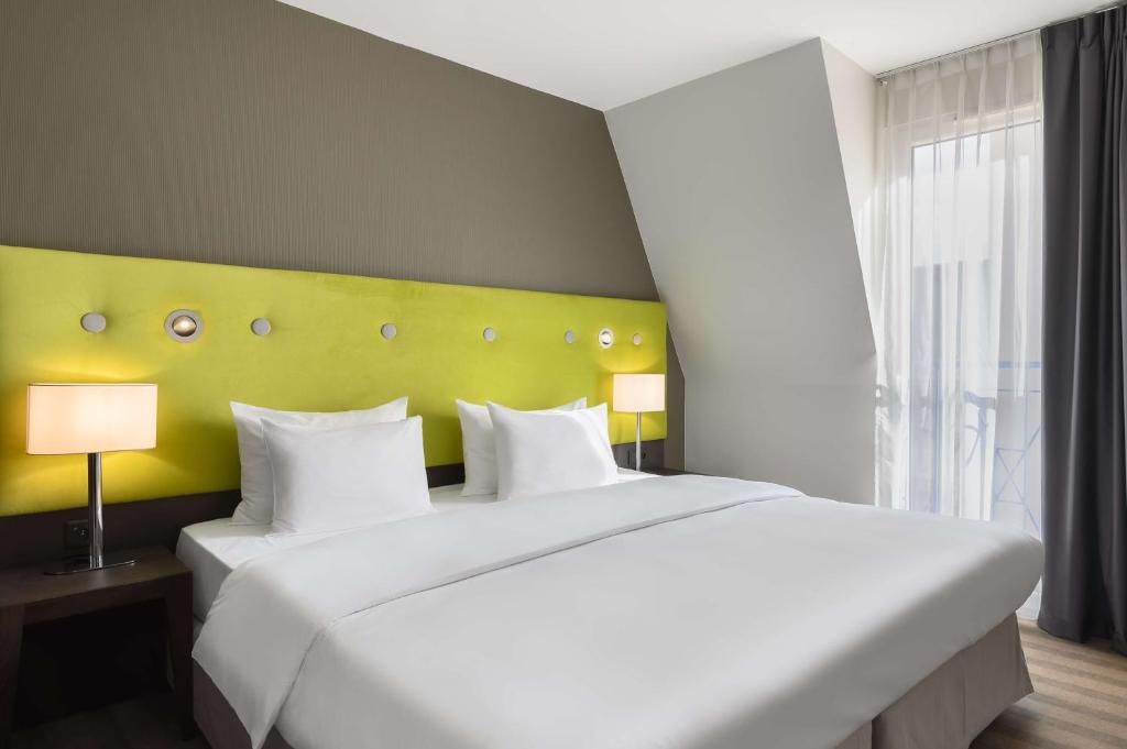 Postel nebo postele na pokoji v ubytování Radisson Blu Sobieski