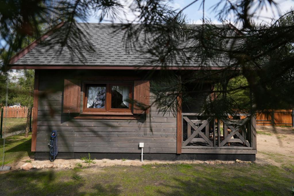 a small house with a window and a dog in it at Nasze Podlasie, Domek w Dubiczach Cerkiewnych in Dubicze Cerkiewne