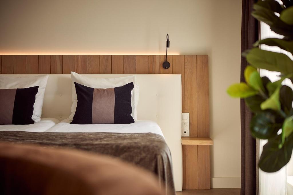 Postel nebo postele na pokoji v ubytování Van der Valk Hotel Dennenhof