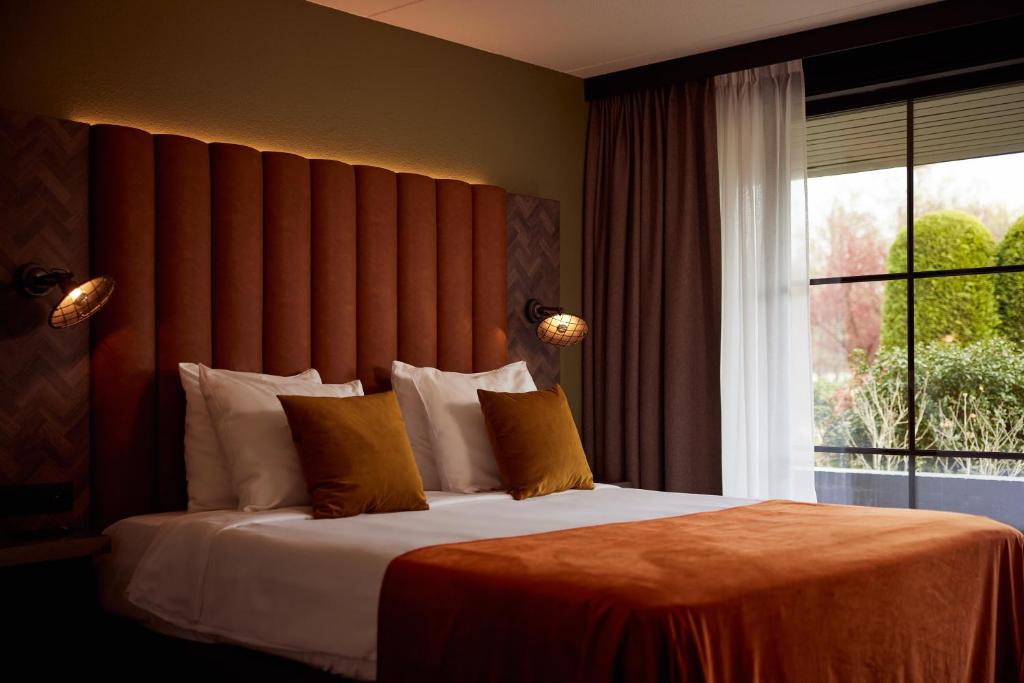 Postel nebo postele na pokoji v ubytování Van der Valk Hotel Dennenhof