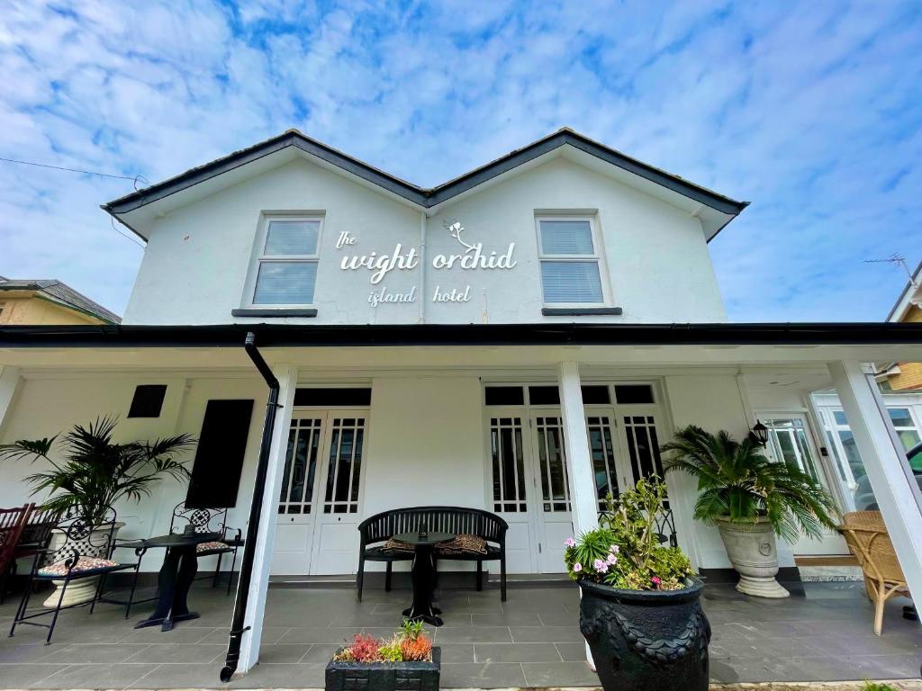 een wit gebouw met een bord dat de nacht wereld dierenhotel leest bij Wight orchid island Hotel in Sandown