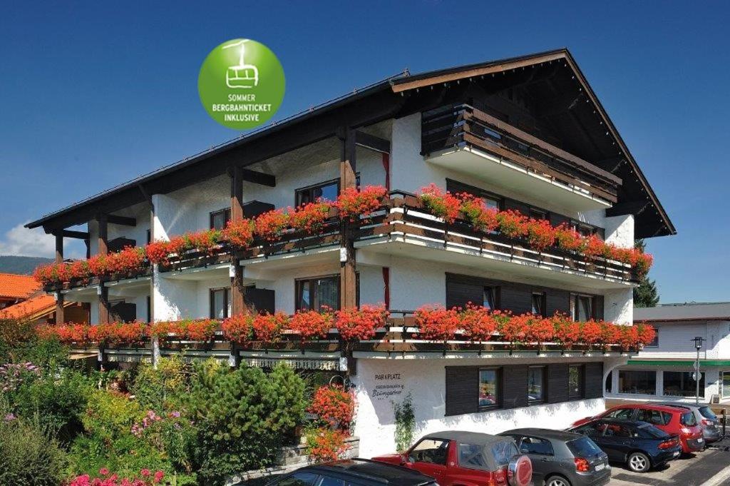 a building with flowers on the balconies of it at Gästehaus Baumgartner in Oberstdorf