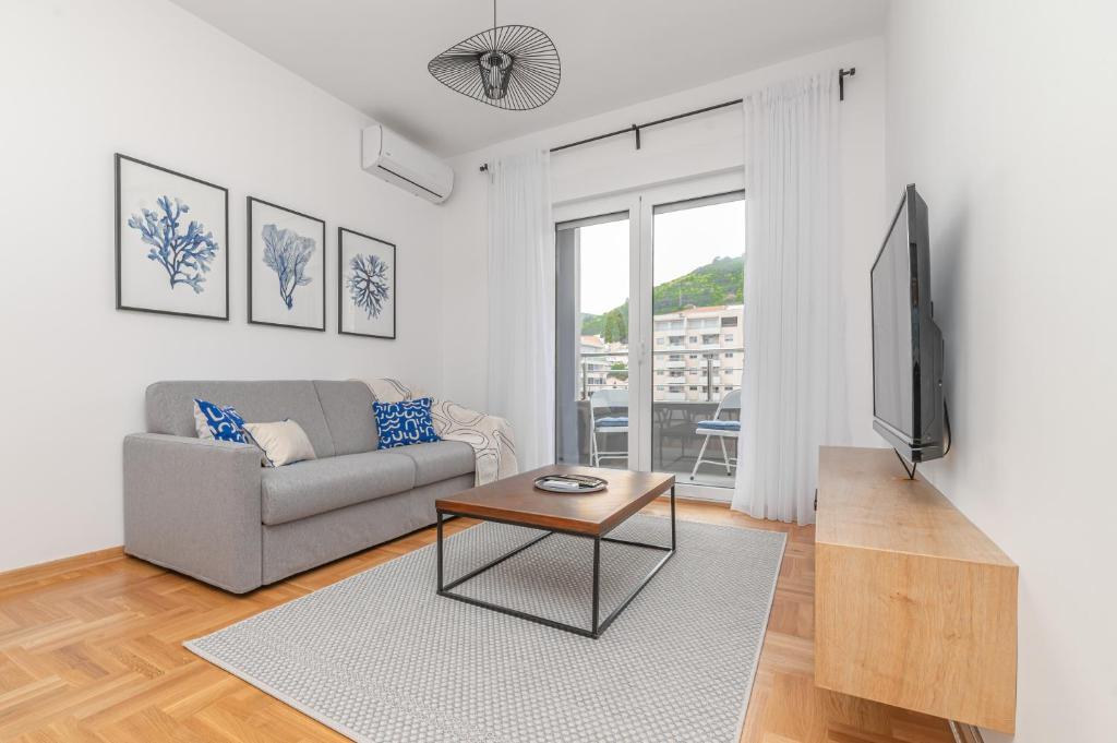 a living room with a couch and a tv at Central One-Bedroom Apartment in Budva