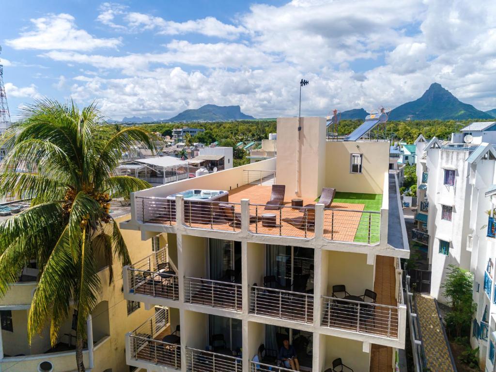 an aerial view of a building with a palm tree at C-view Apartments in Flic-en-Flac