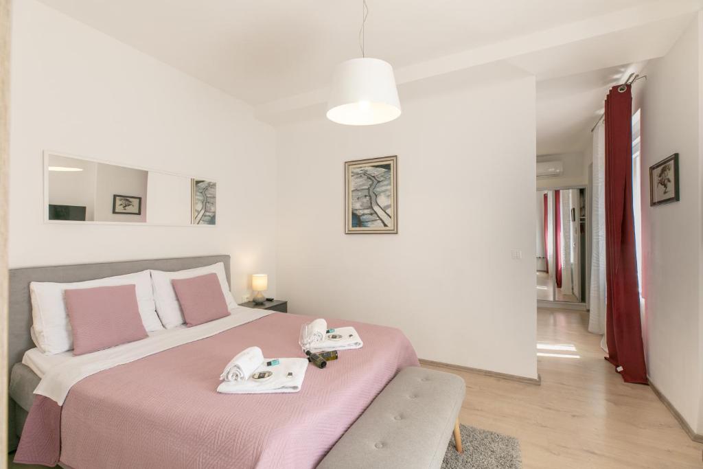 Postel nebo postele na pokoji v ubytování Polai Center Apartments