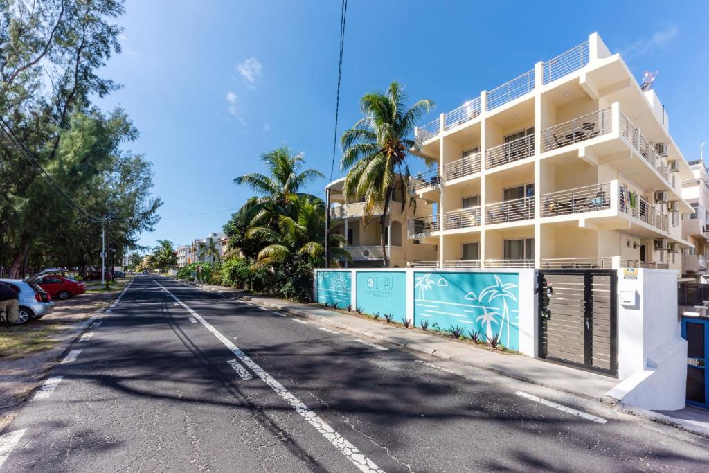 an empty street in front of a building at C-view Apartments in Flic-en-Flac