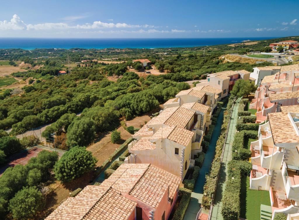 an aerial view of a row of houses and the ocean at Residence PendraSardinia Costa del Turchese by PendraHolidays in Badesi