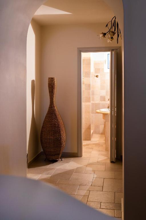 a vase sitting in the corner of a hallway at Flash House in Spetses