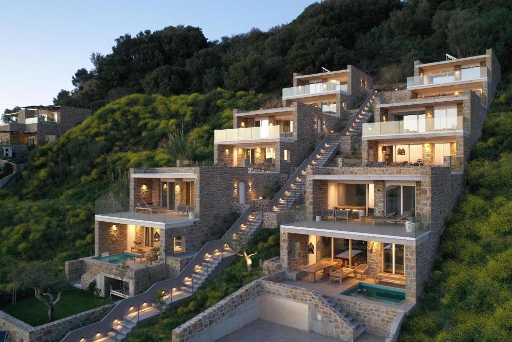 an image of a house on a hill with stairs at Gialova Hills Luxury Villas with Private Pool in Gialova