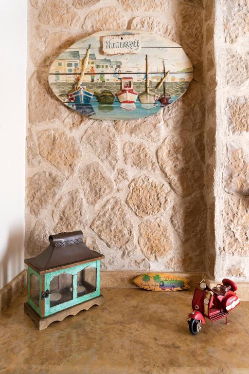 a toy house and a toy scooter in a room at Flash House in Spetses
