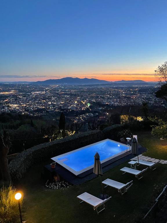 una piscina su una collina con vista sulla città di Villa la Moresca Relais de Charme B&B Adults only a Montecatini Terme