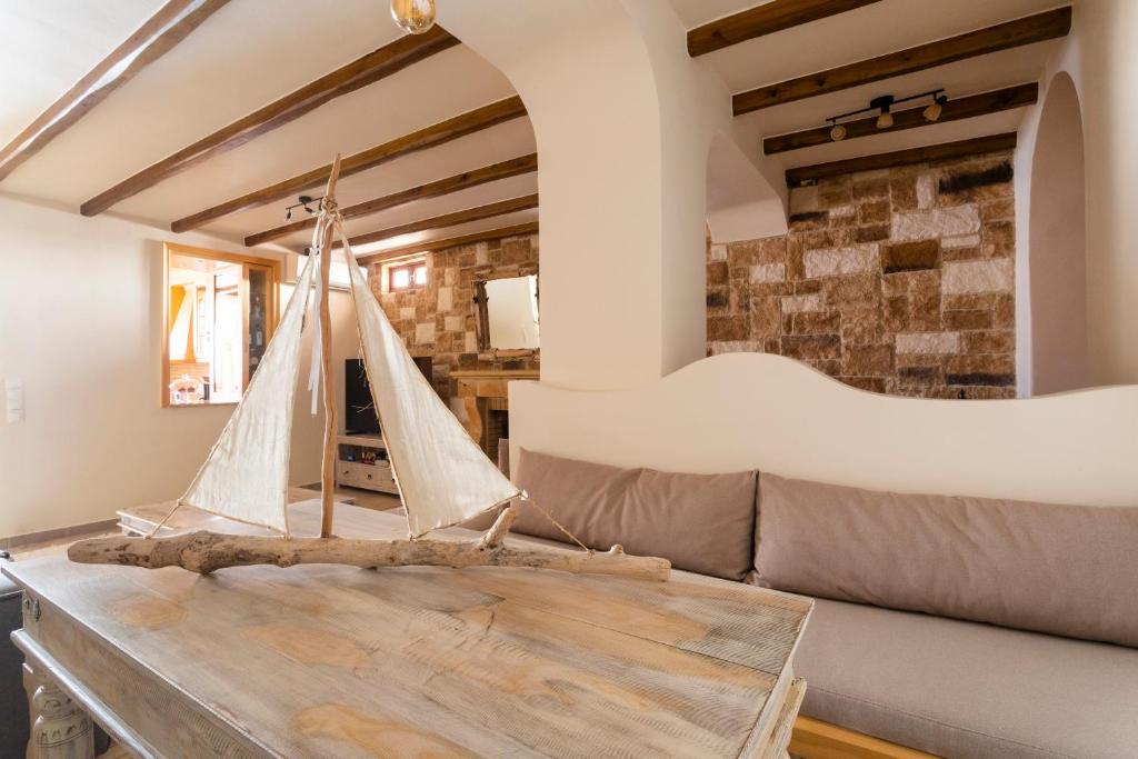 a living room with a wooden boat on a table at Flash House in Spetses