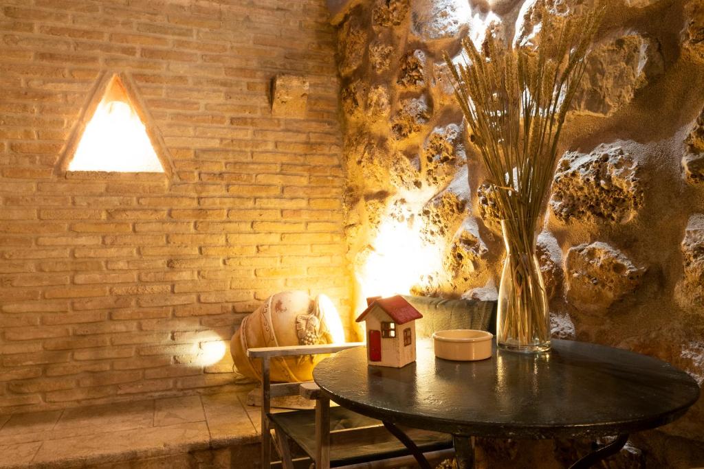 a table with a bird house and a vase at Flash House in Spetses
