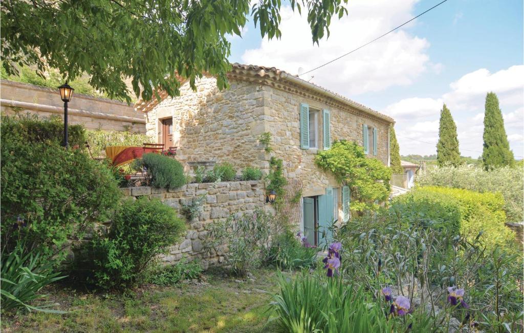 a stone house with a garden in front of it at Amazing Home In Castelnau-valence With Kitchen in Valence