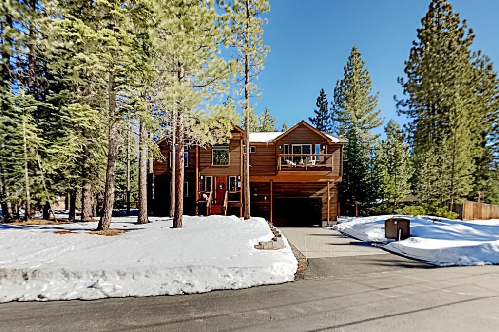 a log cabin in the woods with snow on the ground at Luxury Escape at Thunderbird in South Lake Tahoe