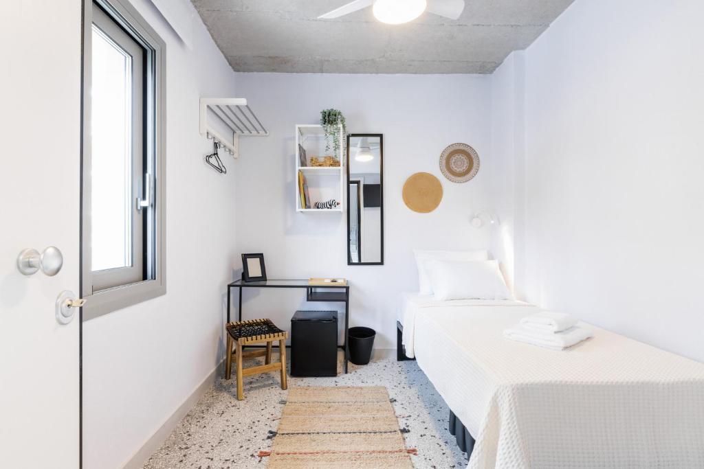 A bed or beds in a room at Boho Rooms