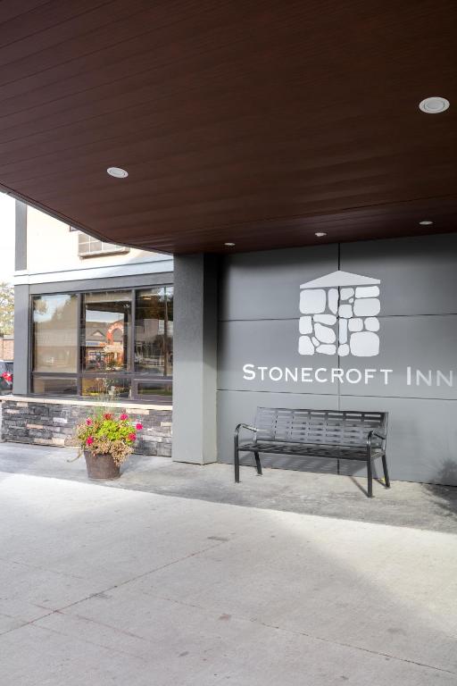 a bench sitting in front of a store front at Stonecroft Inn in Windsor