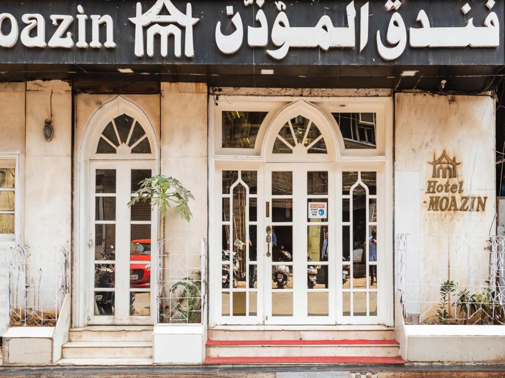 a store front of a building with white doors at Hotel Al Moazin in Mumbai