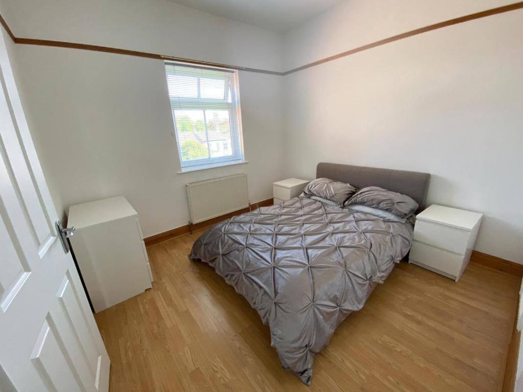 a bedroom with a bed with two night stands and a window at Lovely 1 bedroom apartment in Norwich in Norwich