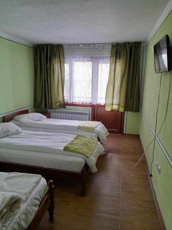 Postel nebo postele na pokoji v ubytování Къща Ради