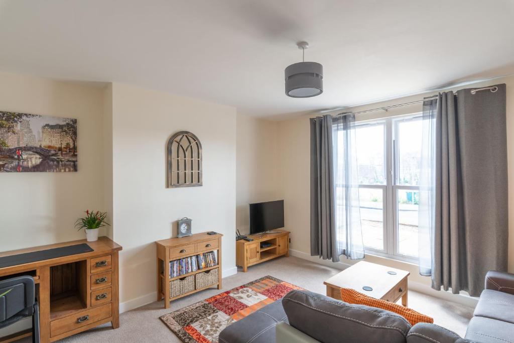 a living room with a couch and a tv at Lower Clarence Road in Norwich