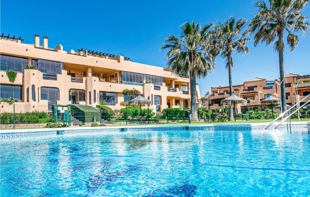 a large swimming pool in front of a building at 2 Bedroom Amazing Apartment In Casares in Casares