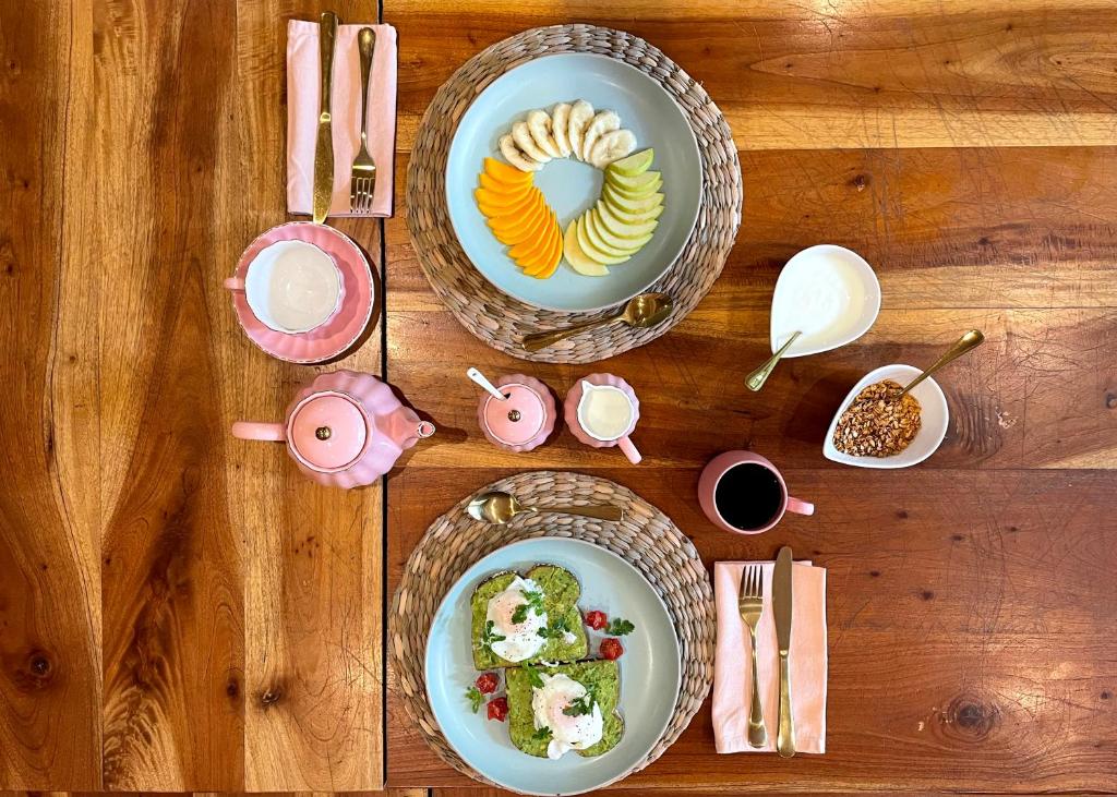 a wooden table with two plates of food on it at Hotel Boutique Refugio 41 in Valladolid