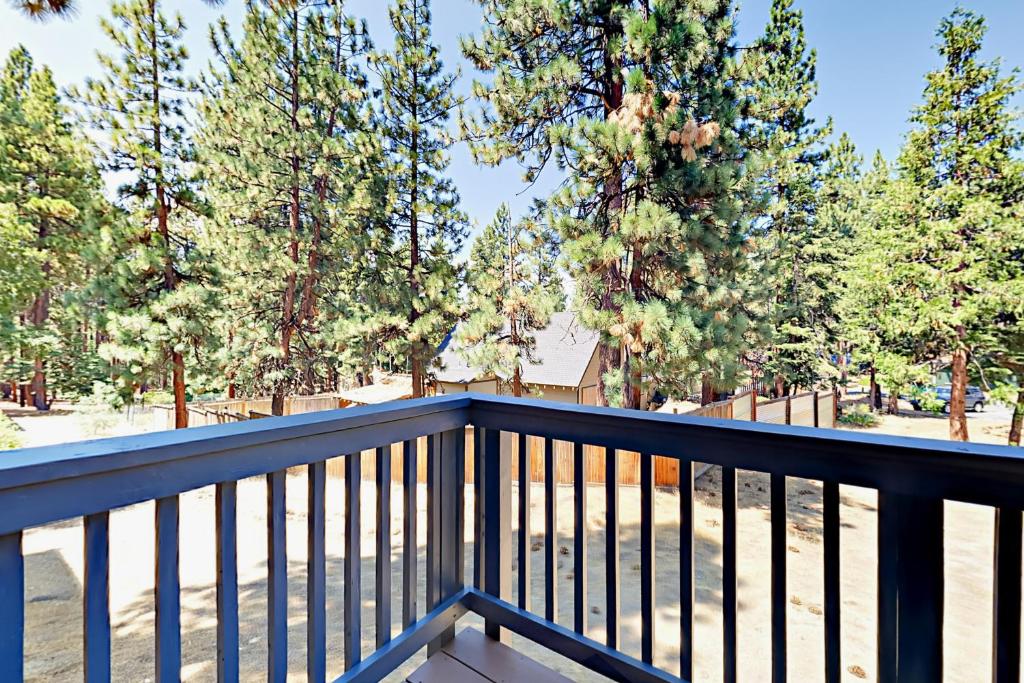 a balcony with a blue railing and trees at Ski Run Village in South Lake Tahoe