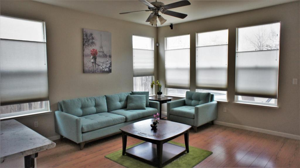 a living room with a couch and chairs and windows at Modern Luxury Living, relax and enjoy your stay! in Rancho Cordova