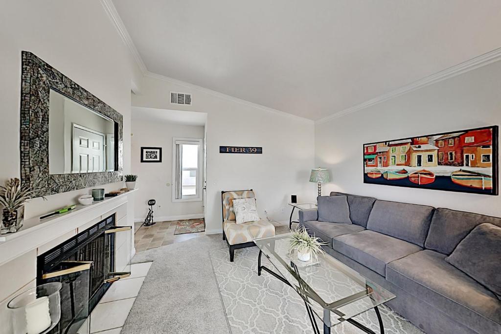 a living room with a couch and a fireplace at Monarch Vista in Dana Point