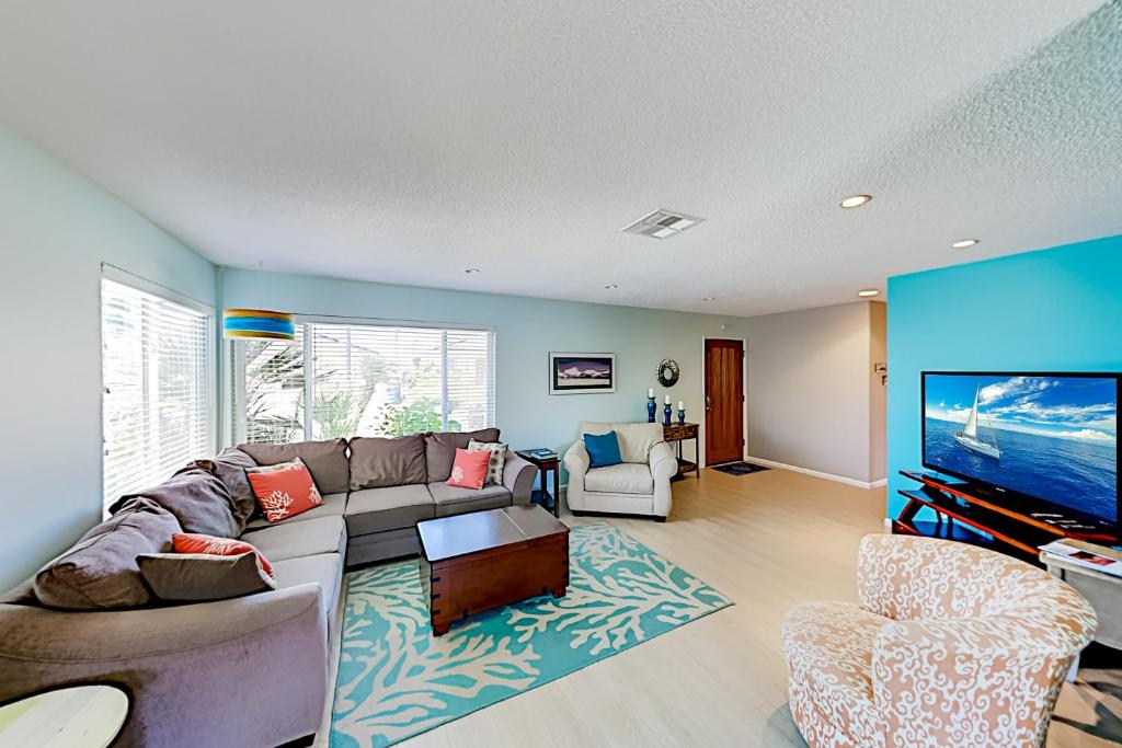 a living room with a couch and a flat screen tv at Verdon Oasis in Morro Bay