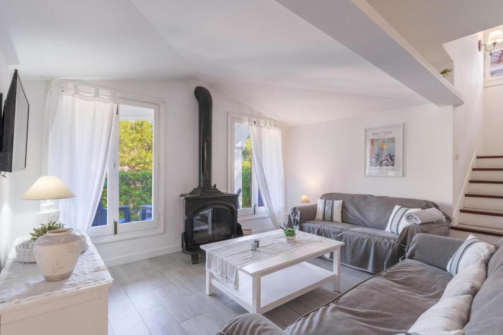 a living room with a couch and a stove at Gorgeous renovated Cala Sant Vicenc Beach Villa in Cala de Sant Vicenc
