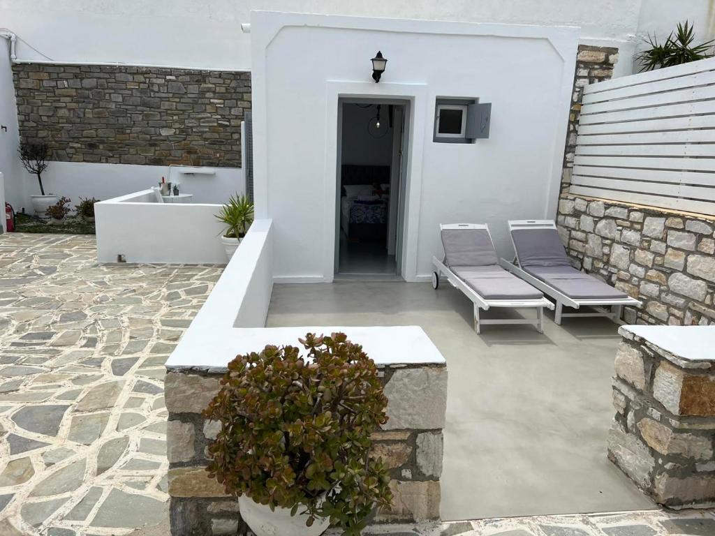 a patio with two benches and a sink at Zoumis Residence in Naousa