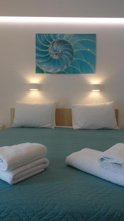 Postel nebo postele na pokoji v ubytování Afroditi Hotel