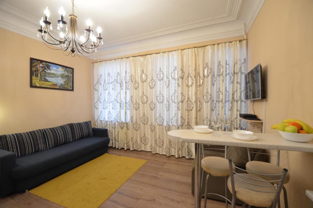 a living room with a couch and a table at Apartment on Dmitrovskiy 7 in Saint Petersburg