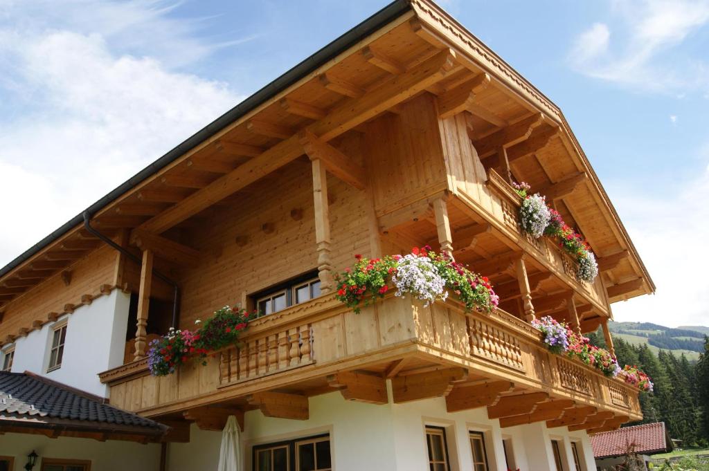 a house with a balcony with flowers on it at Alpbach Loft in Alpbach