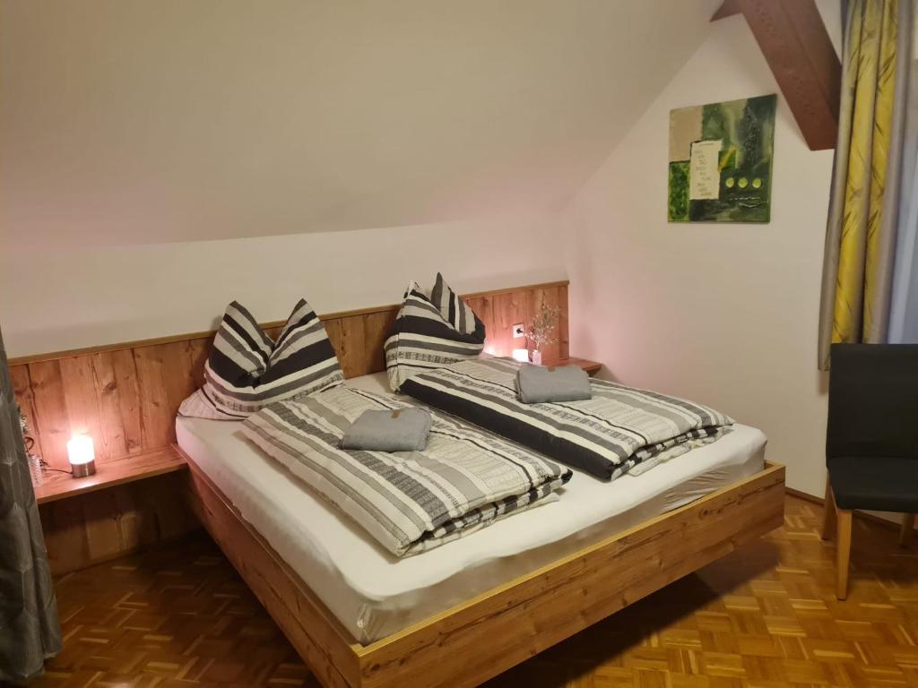 a bedroom with a bed with two pillows on it at Apartment Berg &amp; Naturliebe in Oberweissburg