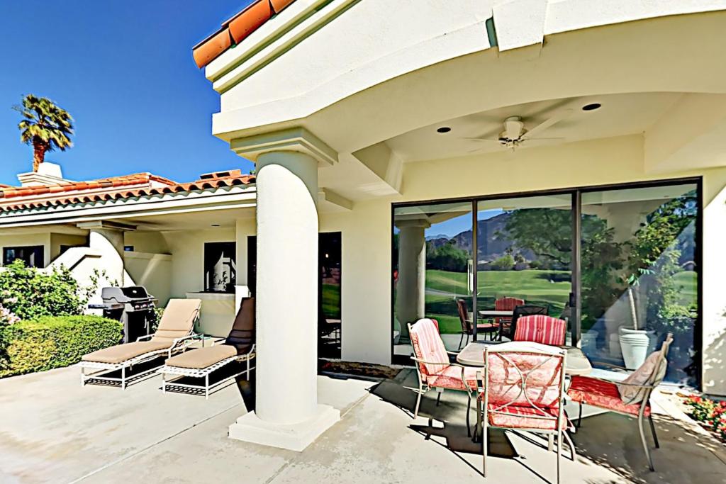 a patio with chairs and tables on a house at Southern Hills Charm Permit# 65256 in La Quinta