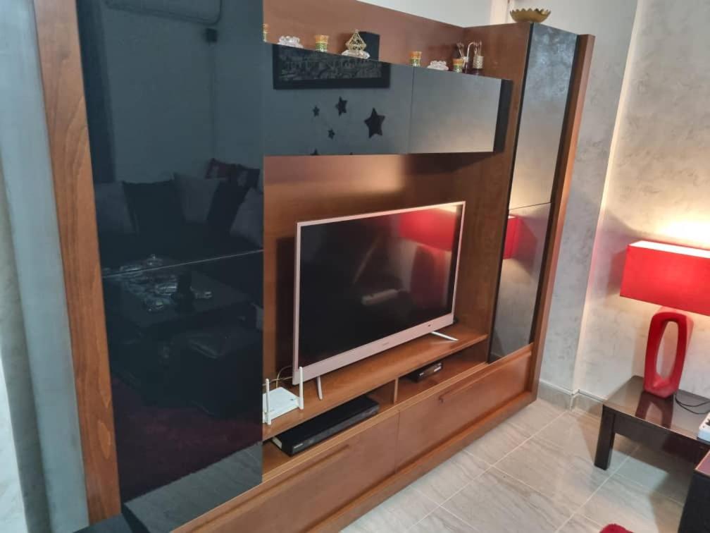 a large entertainment center with a flat screen tv at Maison confortable vue sur mer in Zeralda