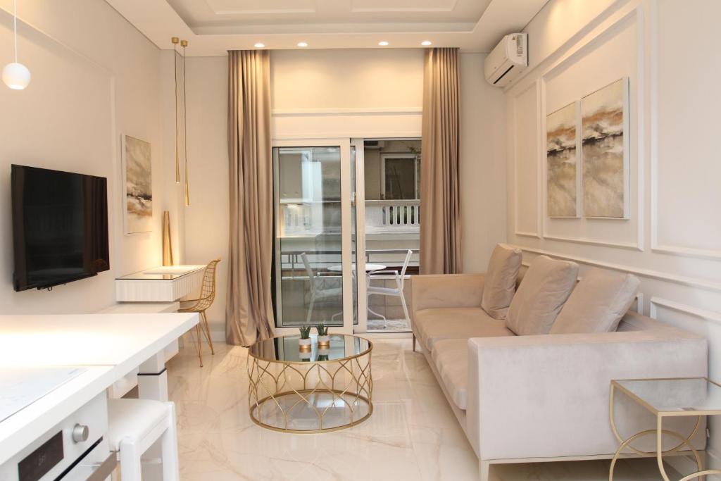 a living room with a couch and a tv at Adri & Marg luxury living in Athens