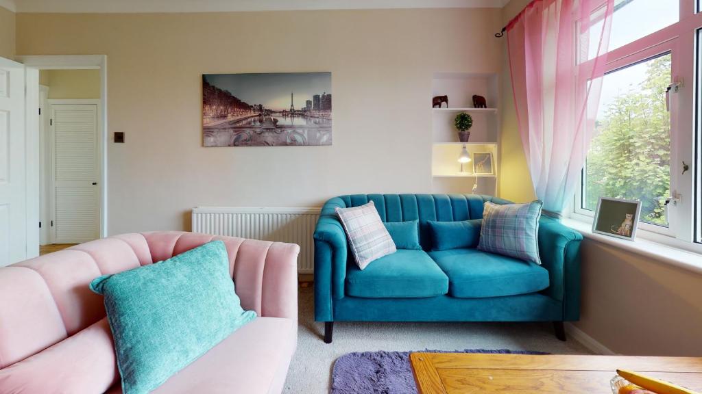 a living room with a blue couch and two chairs at Contemporary 2 Bed Apartment With Private Garden in Maidstone