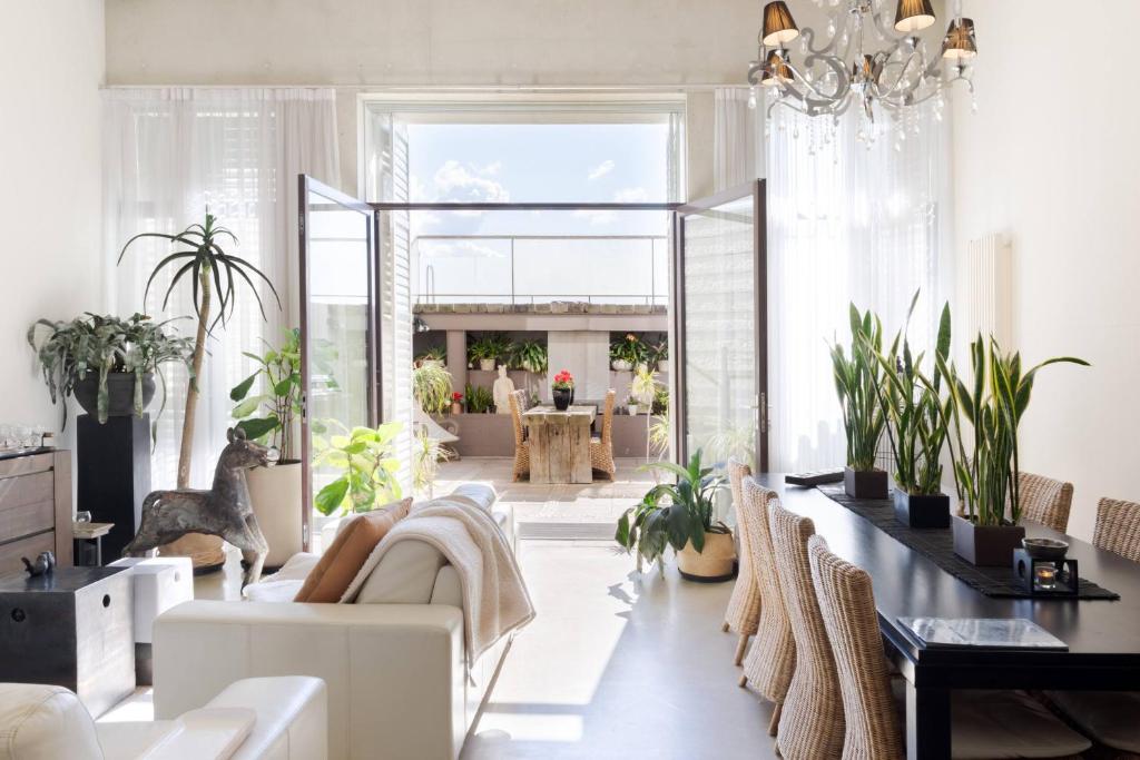 a living room with white furniture and plants at Architectural Home, Pool Oasis/ Steps from Trendy Chapel St. in Melbourne