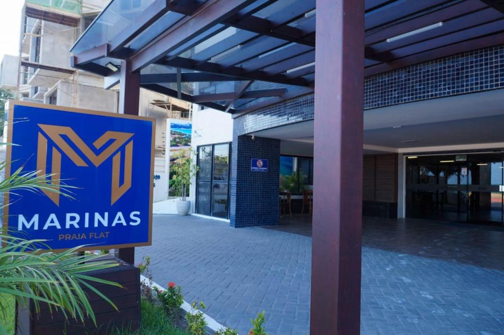 a sign in front of a building with a miamas sign at Marinas Flat 116 in Tambaú