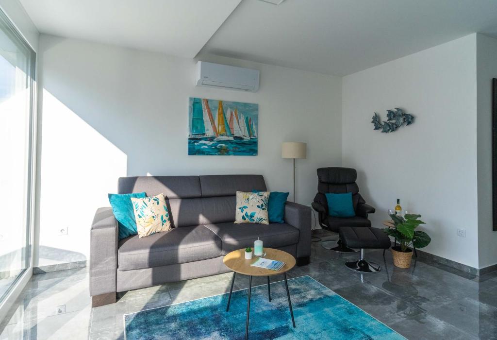 a living room with a couch and a table at Relax Beach Apartman in Fonyód